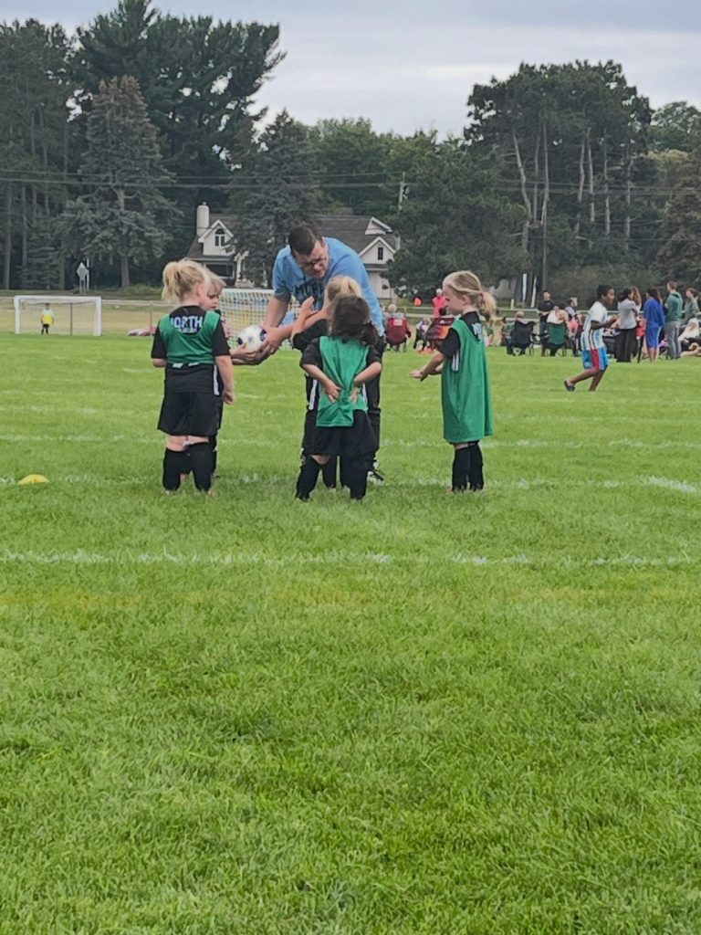 Robert teaching kids soccer